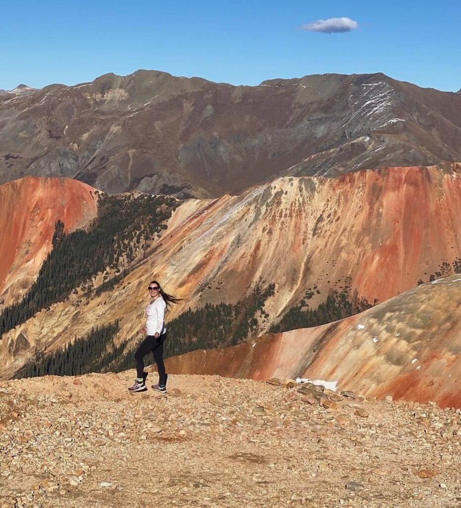 Woman in front of red and brown mountains