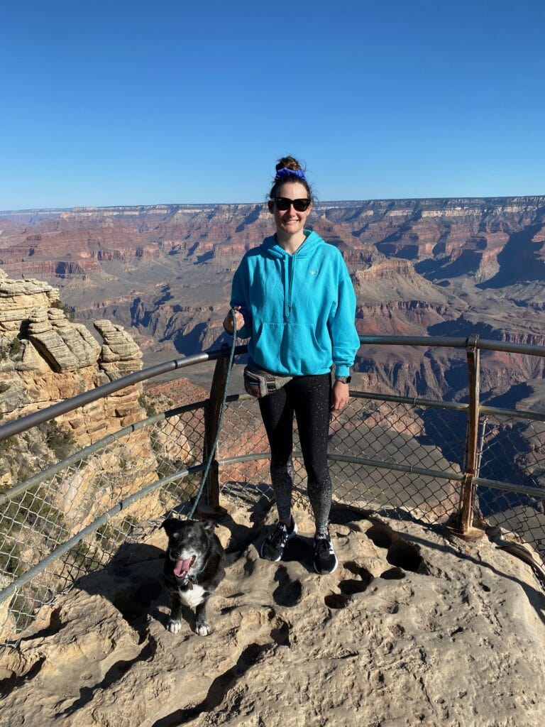 woman and dog posing at Grand Canyon