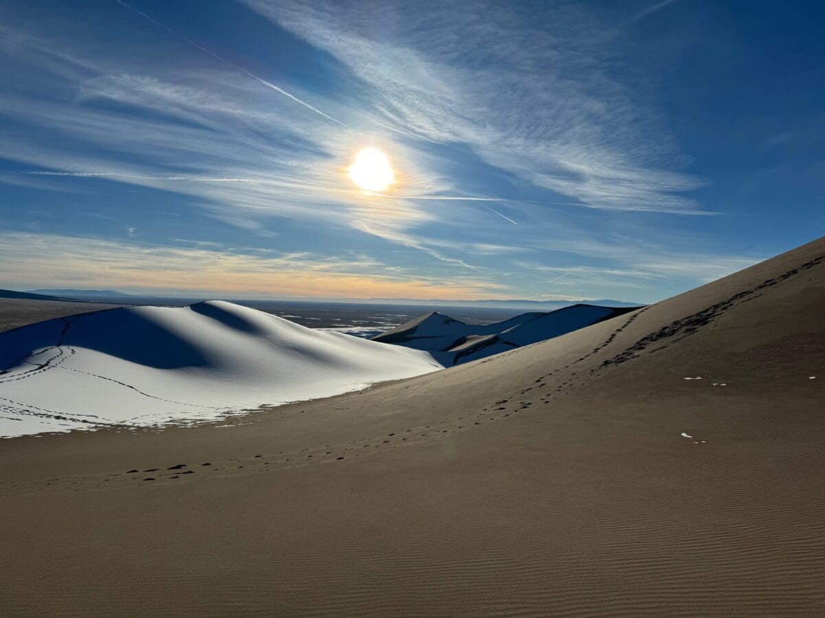 Great Sand dunes National Park with snow-covered sand dune as the sun sets.