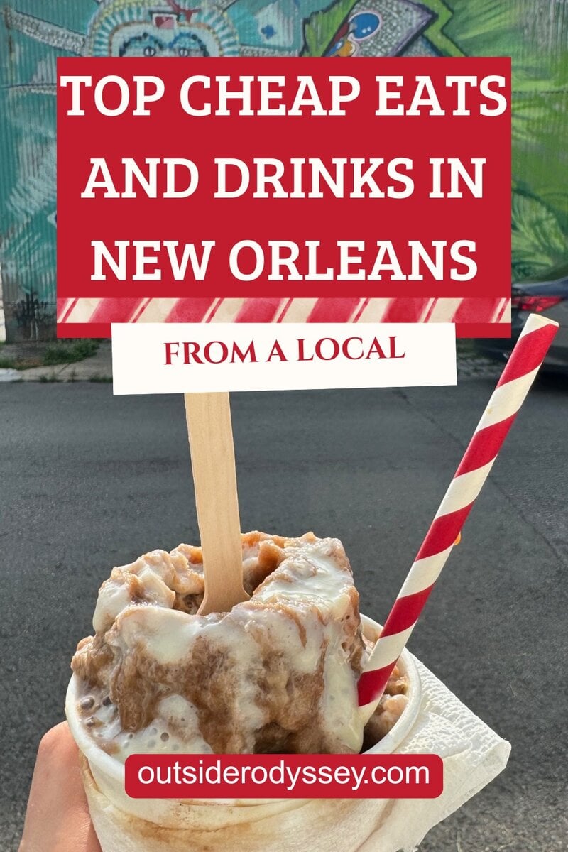 A hand holds a cup of sweet treat topped with icing and a red-striped straw, with text overlay: “Top Cheap Eats and Drinks in New Orleans from a Local.” A colorful mural sets the scene for the best cheap eats in New Orleans.