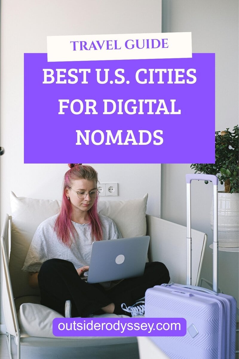 A young woman with pink hair works on a laptop in a bright room, suitcase nearby. Text overlay reads, Best Places to Live for Digital Nomads—outsiderodyssey.com.