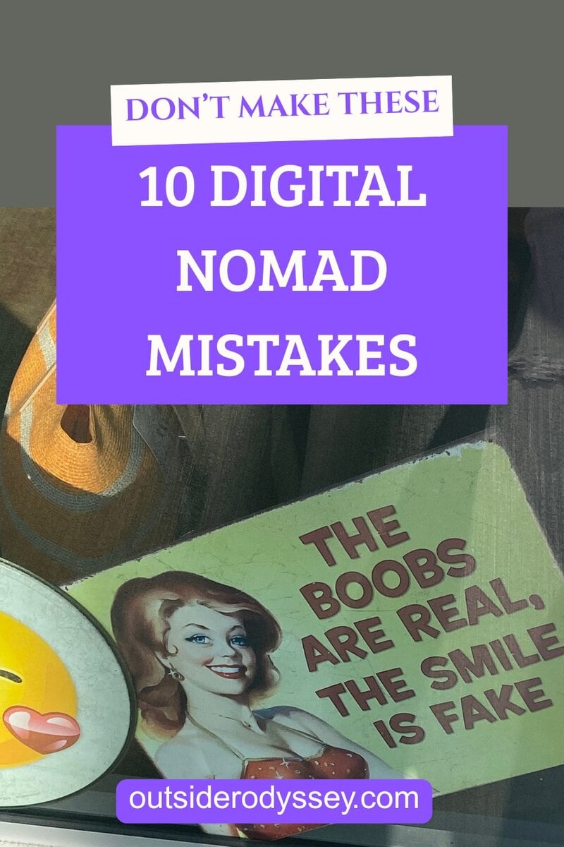 A sign with a retro-style illustration of a woman and the caption The boobs are real, the smile is fake is next to a graphic reading DONT MAKE THESE 10 DIGITAL NOMAD MISTAKES and the website outsiderodyssey.com.