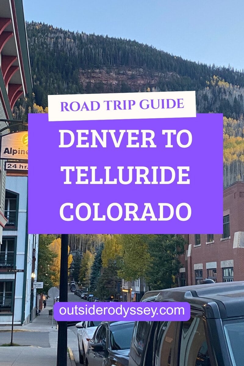 A road trip guide sign reads Denver to Telluride Colorado, capturing the iconic Denver to Telluride drive amid fall trees, buildings, and parked cars. The website outsiderodyssey.com is listed at the bottom.
